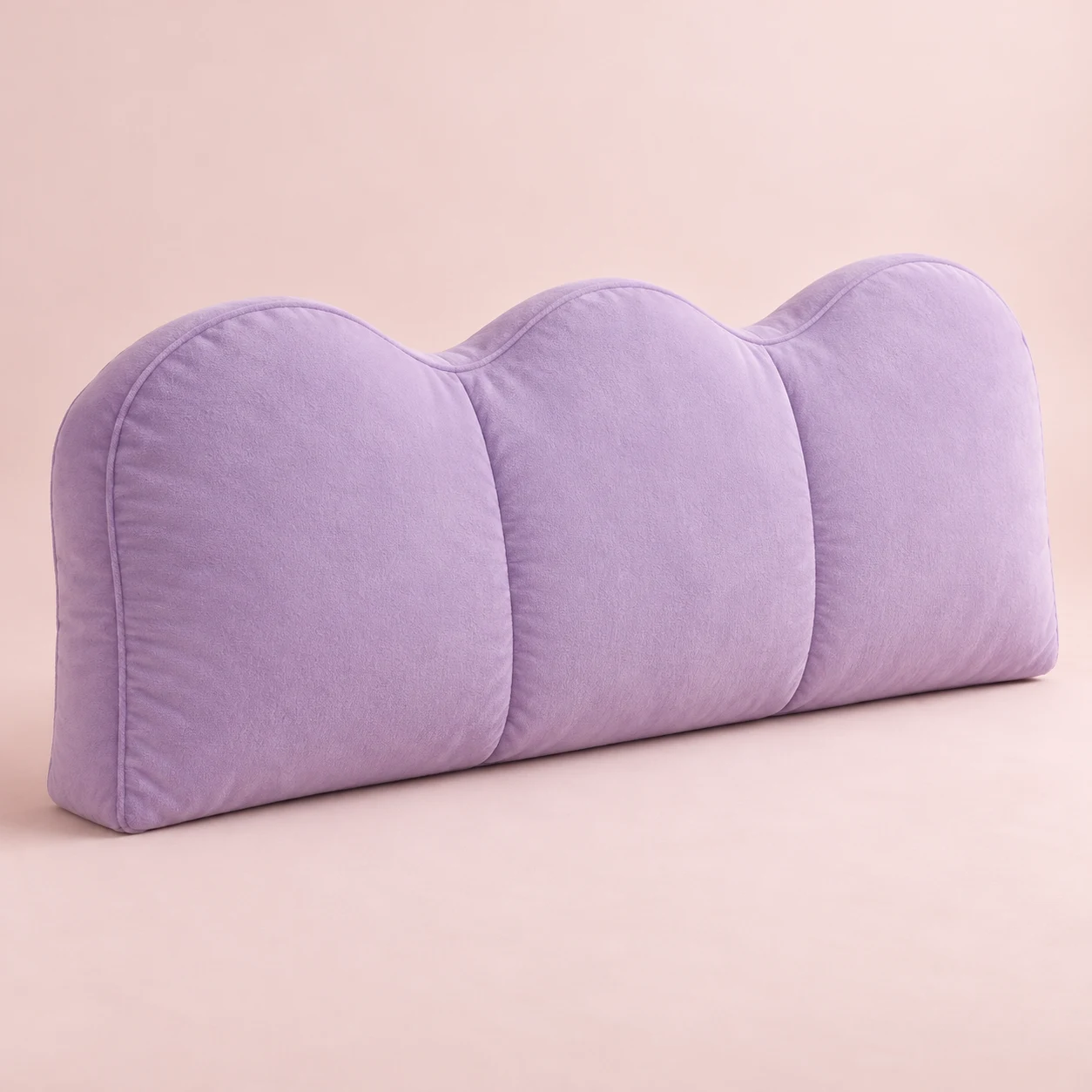 Lilac Wave, Lilac plush wide rectangular bed headboard cushion with three gentle wave lobes along the top, vertical compartment seams